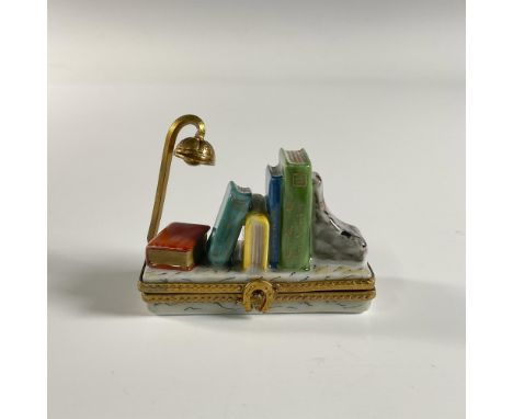 Hand painted treasure box featuring a three dimensional books and a stand light on a book shelf. Limoges France signed with n