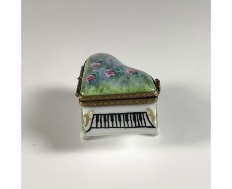 Hand painted treasure box shaped like a piano, adorned with water lilies on ponds, reminiscent of Claude Monet style. When th