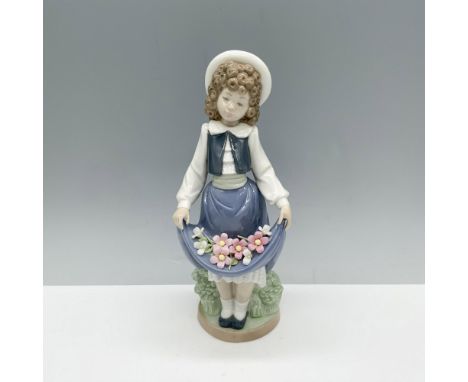 Endearing figure of a curly haired young lady holding flowers in her skirt. Nao backstamp. This item has its original box 6"L