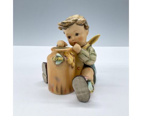 Features a lovely child eating honey from a jar. Goebel Hummel backstamp. Includes the original box, dimensions: 5''L x 7.5''