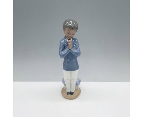 Splendid figure of a pious young man dressed in formal attire with his hands folded in prayer. Nao backstamp. This item has i