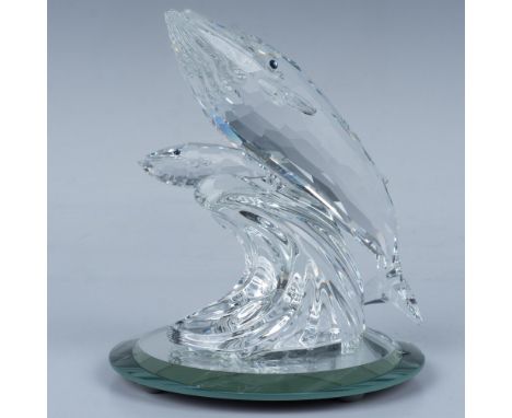 A mother and baby whale swim side by side over a wave, radiating love, both adorned with striking blue crystal eyes. Includes