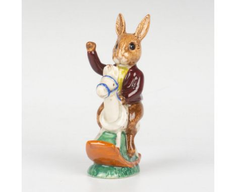 A young boy riding a polka-dotted rocking horse. Wearing a dark red jacket and yellow shirt. Royal Doulton backstamp. Artist: