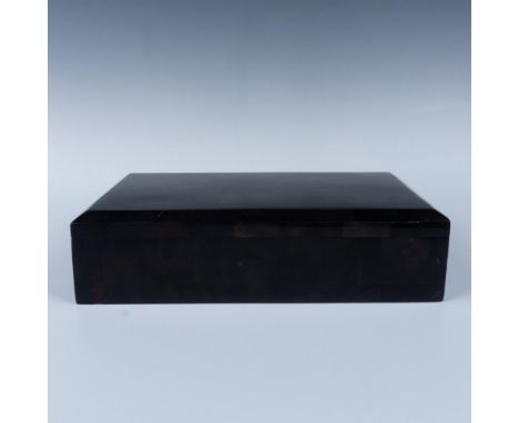 A dark fossil stone covered box with a wooden interior and a hinged lid. Renoir marked and Made In the Philippines stickered.