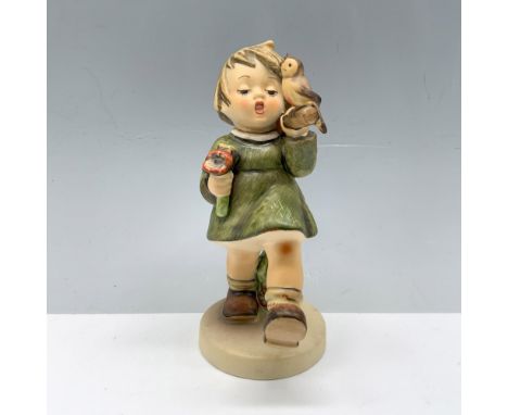 Magnificent figure depicting a young child holding a travel sack and flowers as a bird keeps them company. Goebel backstamp. 