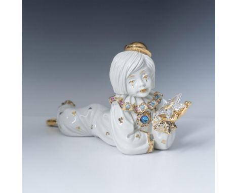 Beautifully detailed figure laying holding a clear crystal star dressed in clown outfit adorned with Swarovski colorful cryst