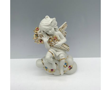 Stunning white porcelain figure of a winged girl sitting on a cloud as she holds a bouquet of Swarovski crystal flowers. Capo