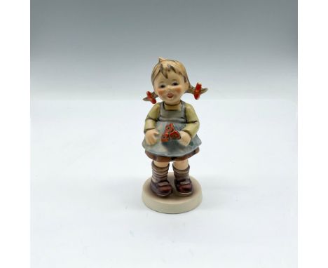 Young figure colored in brown, blue, yellow and orange. Goebel Hummel backstamp. 548. This item has its original box: 4"L x 5