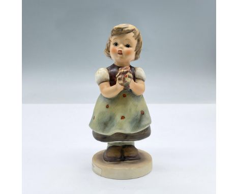 A tender figure of a little girl in a dress holding flowers. Goebel Hummel backstamp. Issued: 20th centuryDimensions: 2.5"L x
