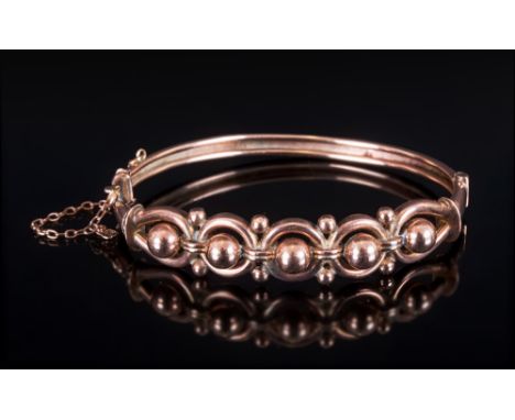 A Victorian 9ct Gold Hinged Bangle with Safety Chain. Marked 9ct. Baubles and Knot Design. 9.8 grams. 