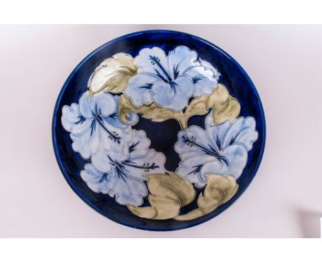 Moorcroft 'Blue Lilies' Bowl, initialled for John Moorcroft, showing pale blue lilies with light green leaves against a deep 