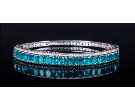 Blue/Green Quartz Bangle, oval cut blue/green quartz set vertically in a millegrain frame across the front of the bangle, in 