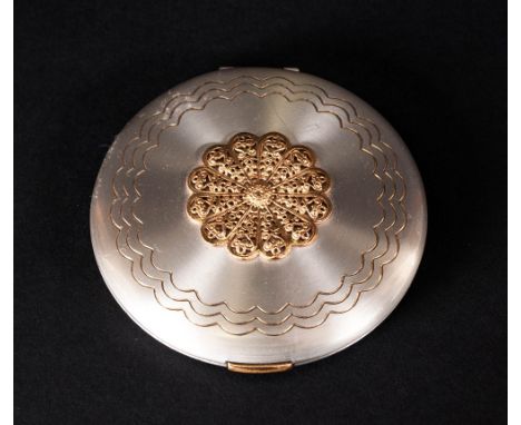 1950's Vogue Compact in a polished steel case with gilt metal roundel. Stamped 'Panities'. Made in England.