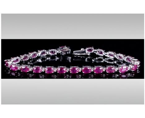 Ruby Tennis Bracelet, 18cts of rubies with a deep fuchsia pink undertone, oval cut and set in silver in a tennis bracelet des