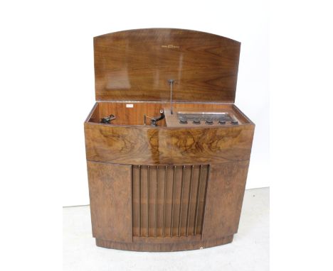 A mid/late 20th century walnut radiogram by Decca comprising record player and tuner, height 84cm.