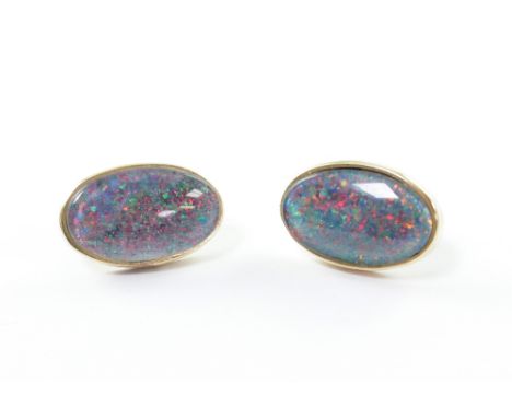 A pair of yellow metal mounted oval black opal earrings with stud backs, width of each approx 2cm, combined approx 8g.