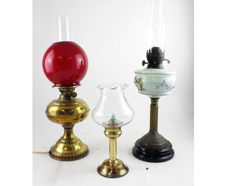 A brass double burner paraffin lamp converted to electricity with red globe and smoke stack, height 54cm and a pale green lat