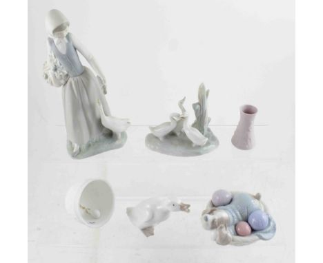 A Nao bisque figure of a goose girl, height 24cm, a further group of geese in the reeds, a dog sleeping in a knitting basket 