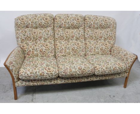 An oak-framed Parker Knoll cottage suite decorated in fine point weave floral tapestry, comprising two armchairs and a three-