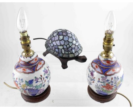 A pair of Oriental-style baluster table lamps, floral decorated and gilt-heightened, on stepped hardwood base, height 20cm an