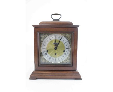 A modern reproduction mahogany bracket clock, the gold dial with spandrels and silver chapter ring inset with Roman numerals 