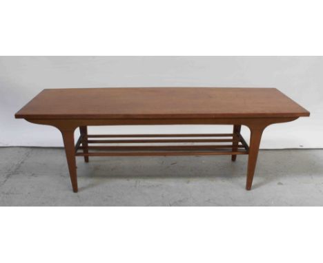 A 1970s teak retro coffee table with magazine rack shelf stretcher below, length 121.5cm. CONDITION REPORT Small amount of da