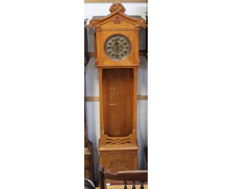 A Continental oak Art Nouveau longcase clock c1910, the silvered brass dial set with Arabic numerals and with chrysanthemum e