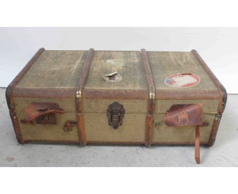 An early 20th century canvas travel trunk with wooden laths and various Cunard Line labels to include Cabin Class labels etc,