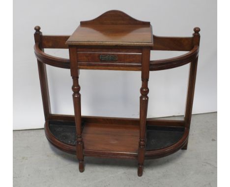 A Victorian Aesthetics walnut hall stand, the table top and single frieze drawer flanked on either side by stick stand hoops 