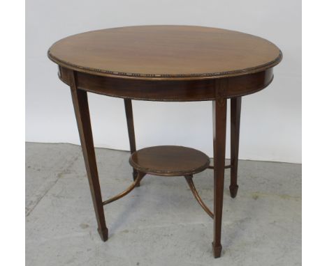 A 1930s mahogany elliptical occasional table with beaded edge supported on square tapering legs to square feet united by shel