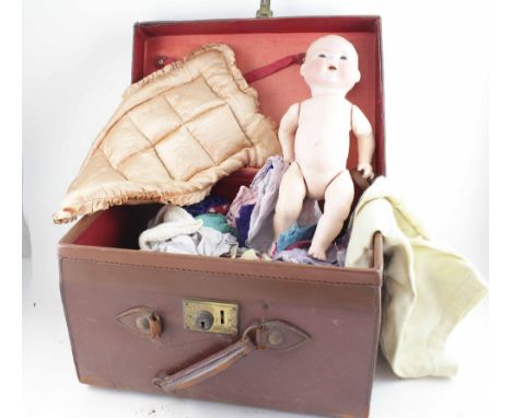 An Armand Marseille German bisque head doll numbered 351.15K, with composite body and closing paperweight eyes, with a collec