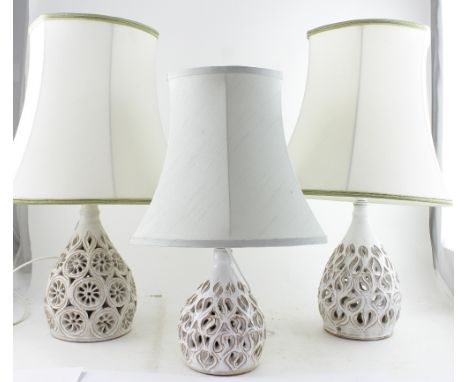 Three tin glazed earthenware lamp bases with floral and flame decoration, comprising two larger examples, height 25.5cm and o