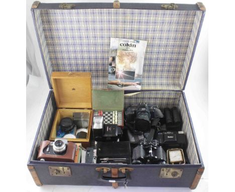 A blue painted canvas suitcase with wooden banding, containing a selection of vintage cameras and camera equipment, width of 