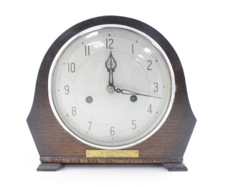 A 1950 Smiths oak mantel clock with twin train movement striking on coiled rod, the dial set with Arabic numerals and chrome 