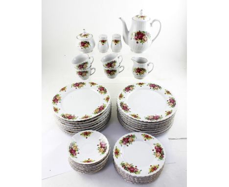 A rose pattern part dinner and tea service comprising sixteen dinner plates, seven side plates, eight saucers, four cups, mil