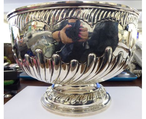 A late Victorian silver pedestal rose bowl with embossed, wrythen moulded, demi-reeded ornament  London 1893  9.5''dia       