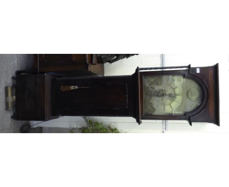 An early 19thC mahogany longcase clock, the hood with a level top, over an arched window, the straight trunk flanked by ropet