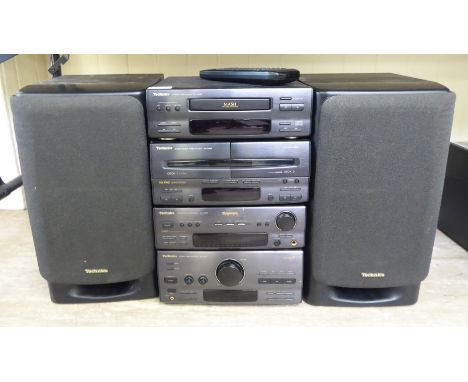 A Technics stacking stereo system, viz. a compact disc player, twin cassette deck, a sound processor, tuner amplifier and a p