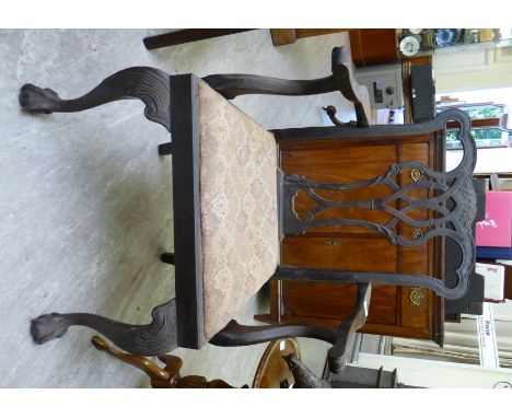 A late 19thC Chippendale design, mahogany framed elbow chair with a ribbon carved splat, the arms on swept supports, the upho