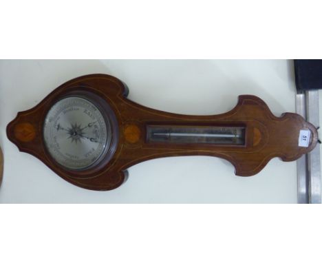 An Edwardian satinwood and ebony string inlaid mahogany backed onion topped banjo shaped aneroid barometer with an engraved, 