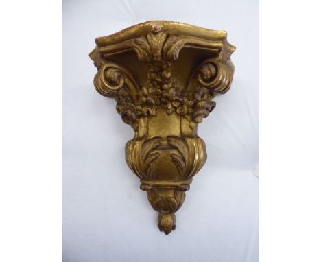 An early 20thC Continental, floral, foliate and scroll carved giltwood wall bracket  8''h       OS5