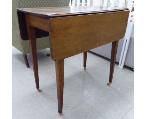 An early 20thC light oak country made Pembroke style table, raised on square legs and casters  29''h  29''w          S