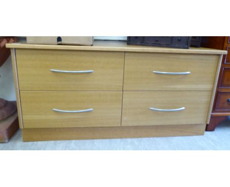 A modern light oak finished cabinet with four drawers, on a plinth  23''h  46''w        F