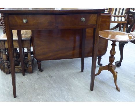 An early 19thC mahogany dropleaf dining table, raised on ring turned legs and casters  27''h  36''L; a mid 20thC two drawer b