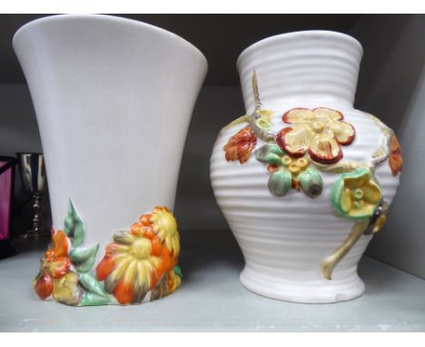 A Clarice Cliff Newport pottery vase of ribbed baluster form, decorated with moulded flora  7''h; and another Clarice Cliff, 