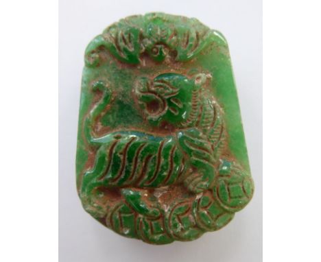 A carved jade pendant, decorated with Dogs of Fo and foliage      11