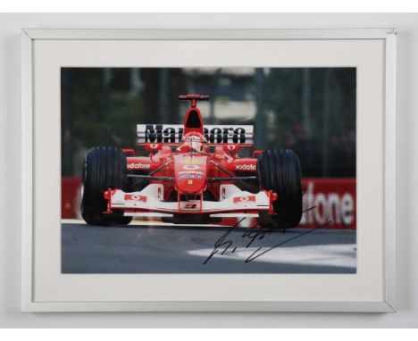 AUTOGRAPHS. A collection of twelve photographs signed by motor racing drivers, each 20cm x 29cm, including Michael Schumacher