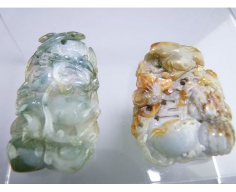 CARVED JADE PENDANTS x 2, one depicting a rabbit amongst vegetables, 5cms and one depicting a mythical beast amongst waves, 6