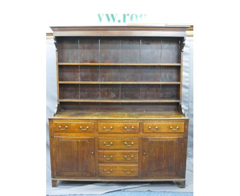 NORTH WALES OAK DRESSER CIRCA 1820, canopy three shelf rack with wide back boards and shaped side detail over a base having a