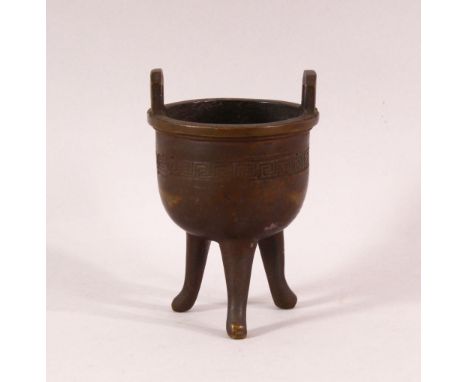 A SMALL 19TH CENTURY CHINESE TWIN HANDLE TRIPOD CENSER, the body with greek key decoration, 9.5cm